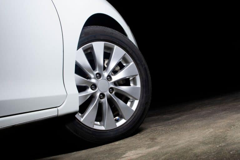 Alloy wheels of a white car are turning on the cement road of parking lot, How To Mark Tires For Rotation?