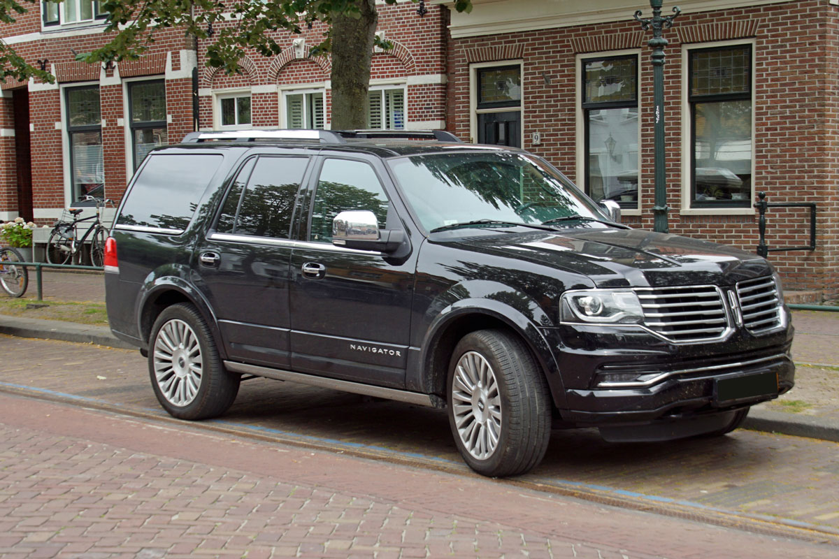 Black Lincoln Navigator parked by the side of the road