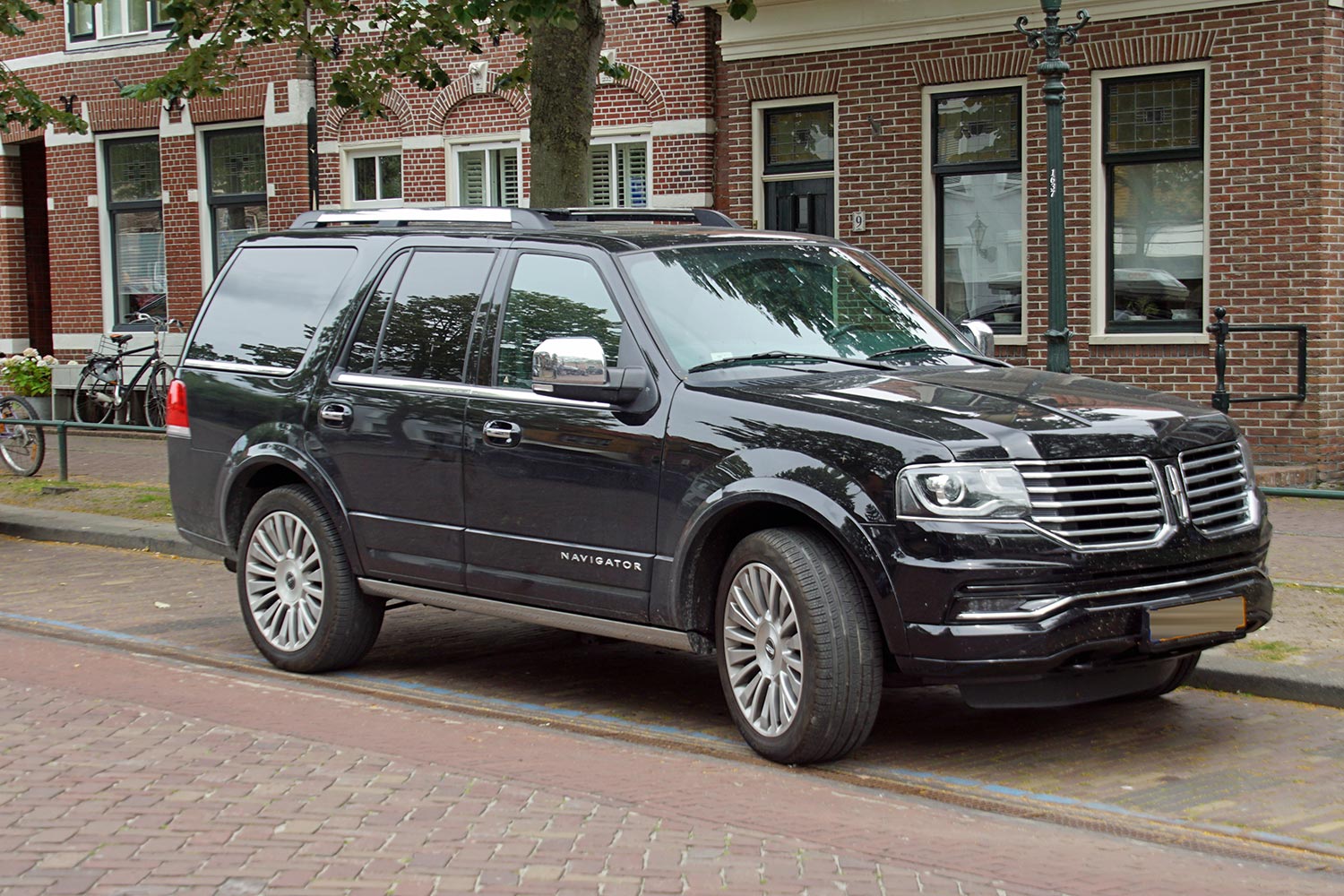 Black Lincoln Navigator parked by the side of the road