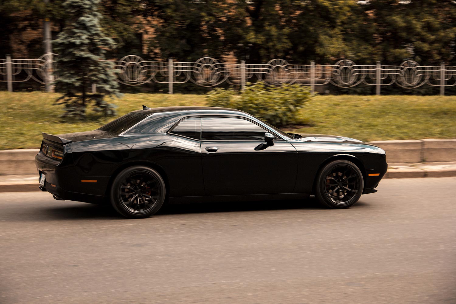 Black muscle car Dodge Challenger on the road