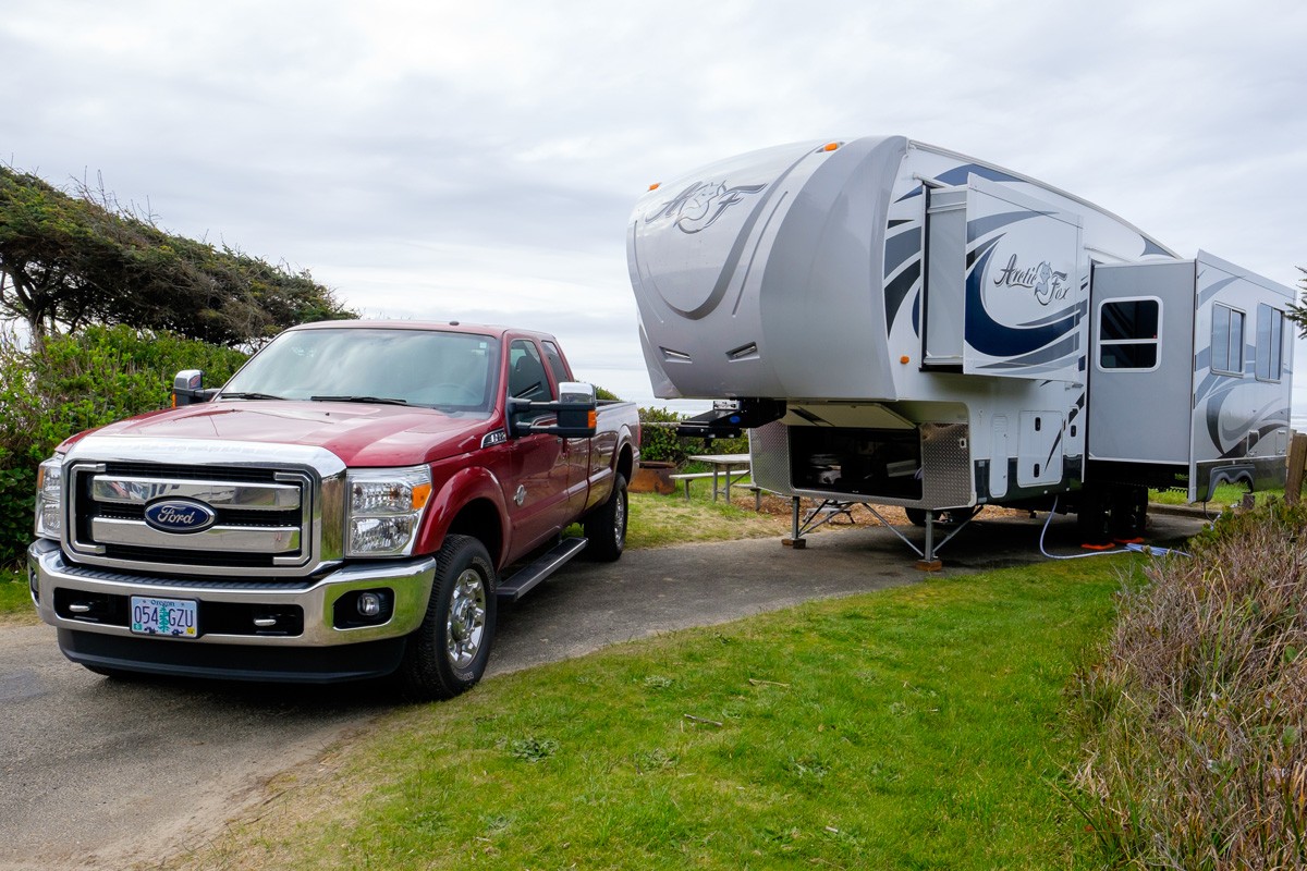 Campsite with a large Arctic Fox 5th Wheel and a Ford F350 truck.