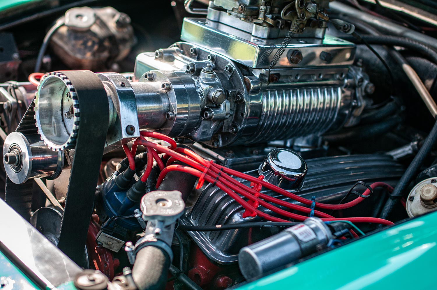 Classic car engine accompanied by a huge supercharger