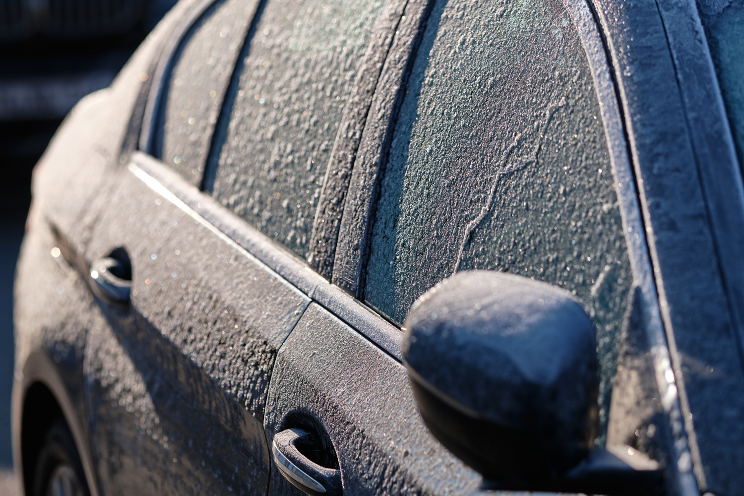 Detail of a frozen car on a cold and sunny winter morning