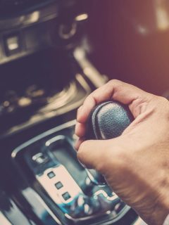 A driver hand shifting the gear stick, Can You Use Engine Brake In Rain, Ice And Snow?
