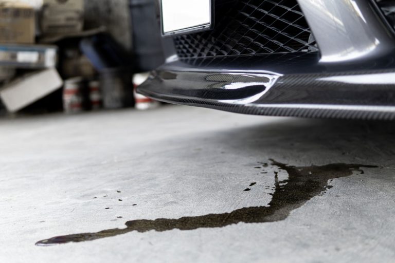 Engine oil stains of car Leak under the car when the car is park In the garage service floor photo concept for checking, Car Leaking Water When Parked - What To Do?