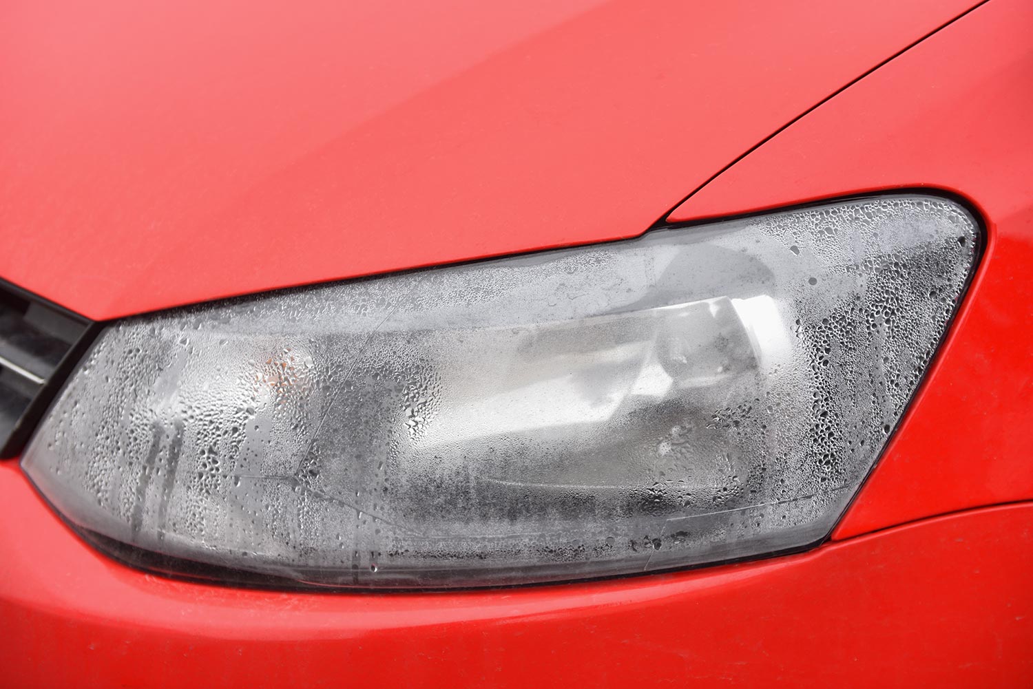 Foggy headlight with condensation in a modern car
