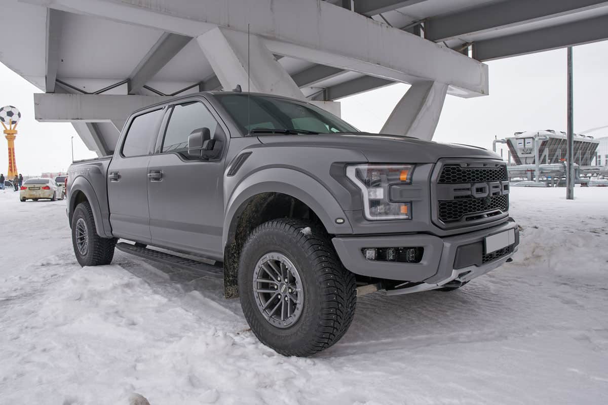 Gray colored Ford F-150 parked under a bridge