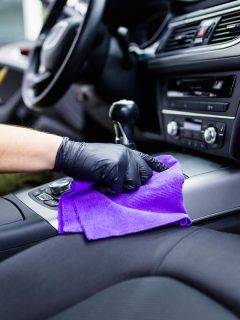A man cleaning car interior, How To Keep Car Interior Dust Free [6 Ways]