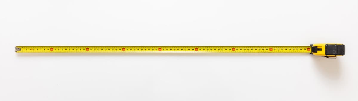 Measure Tape isolated on white background. Metal meter long yellow color, construction hand tool top view, banner.