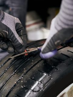 Mechanic Preparing the Nail Hole in a Punctured Tire by Cutting the Injection Moulding before Putting in the Crude Rubber Filler - How To Cut Tires for Disposal