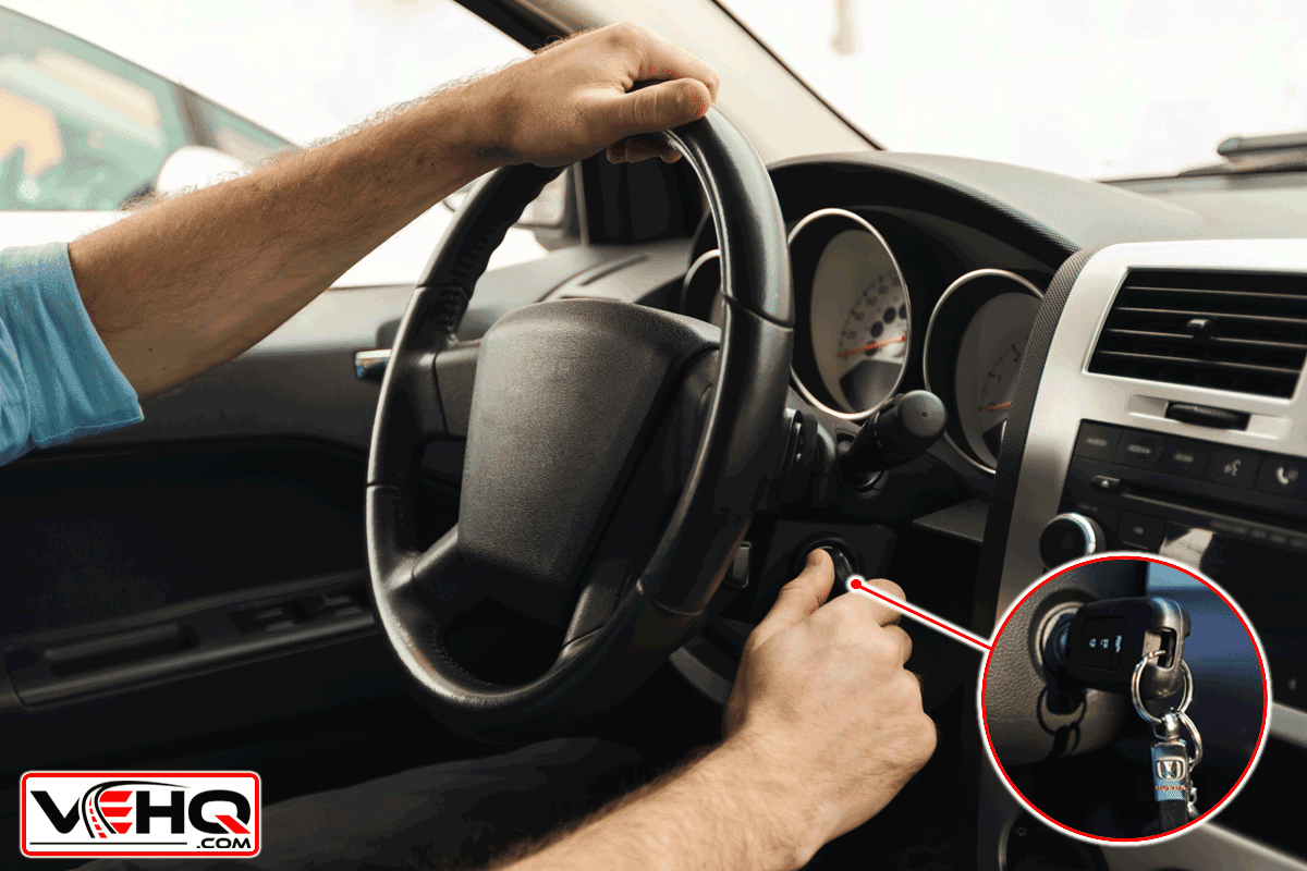A guy hand holding on steering wheel and removing key on ignition, My Honda Civic Key Is Stuck In The Ignition - What To Do?