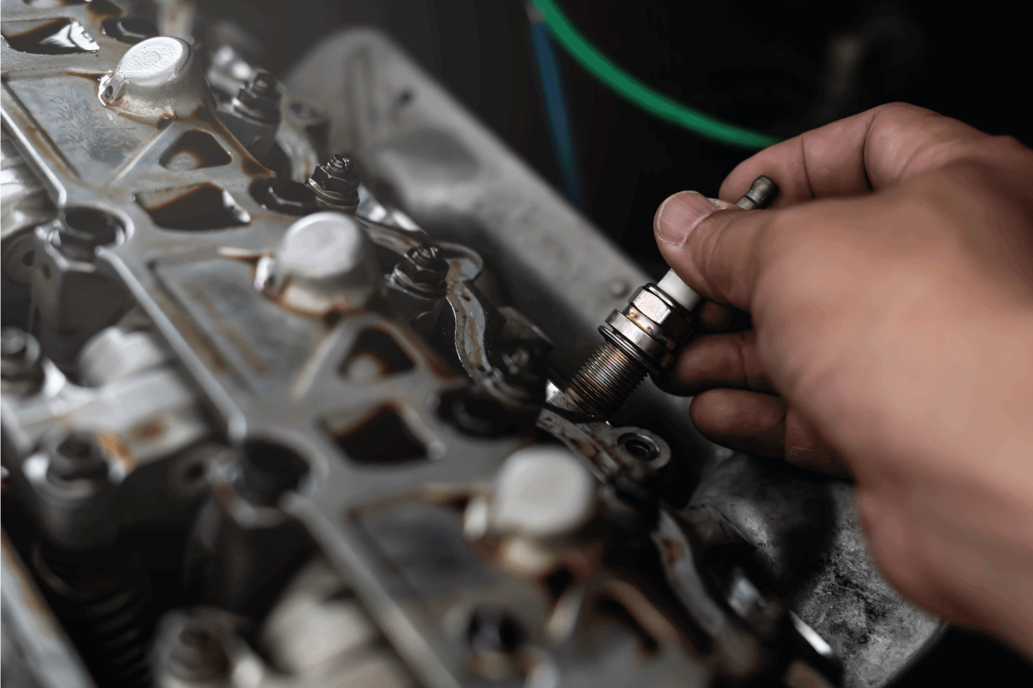 Old Car spark plug in a hand of Technician remove and change in engine room
