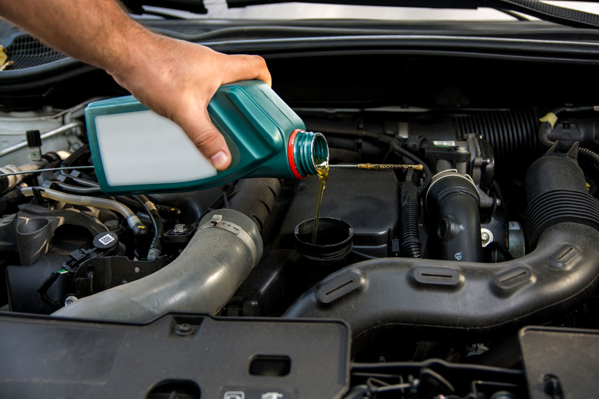 Pouring 20W-50 oil to the car engine