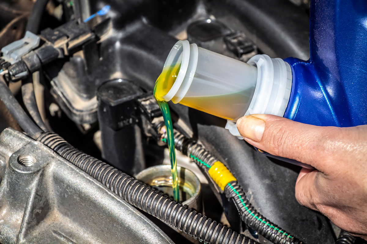 Pouring new oil to the car