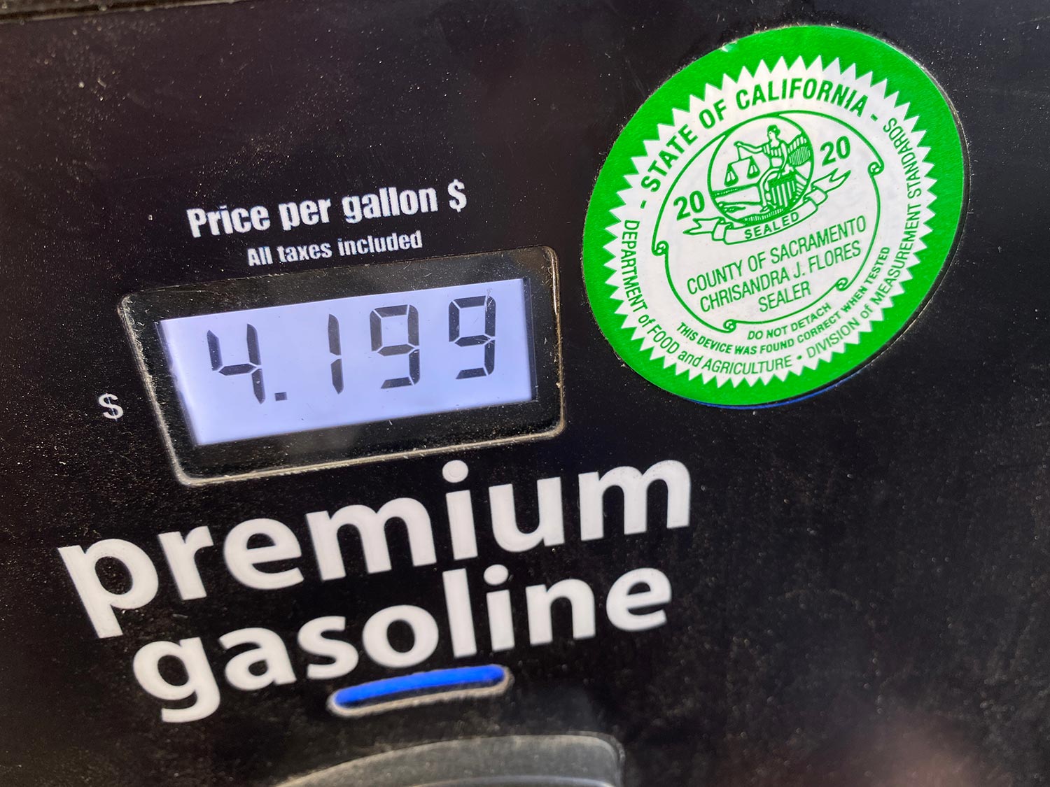 Premium gasoline digital price display on black background of a pump