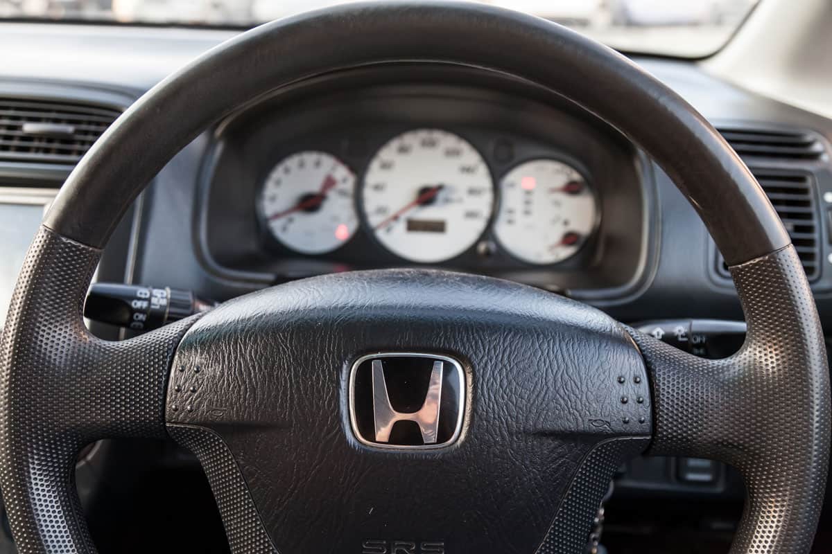 The interior of an old Japanese car Honda Stream with a view of the dashboard, steering wheel, speedometer and