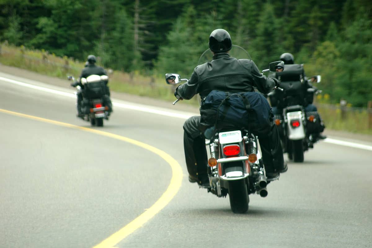 Three guys riding motorcycle on the highway
