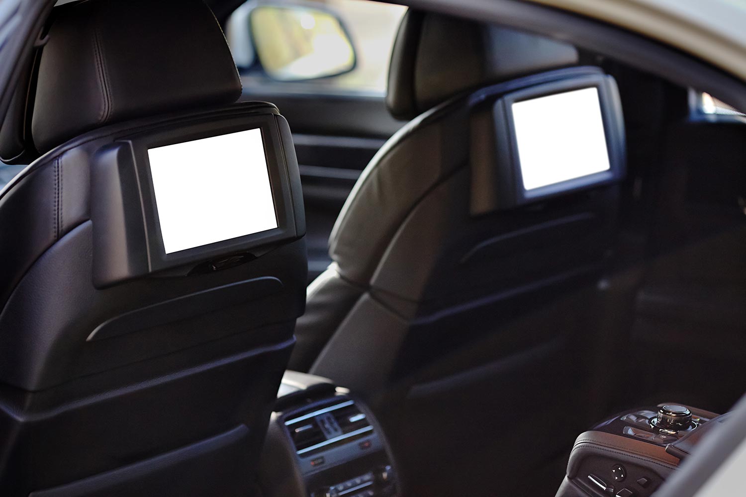 Two white displays for back seats passenger with media control panel