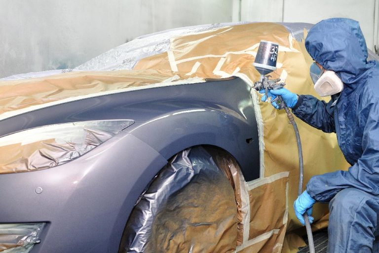 Worker painting car in a paint booth, Does 3M Tape Damage Car Paint?