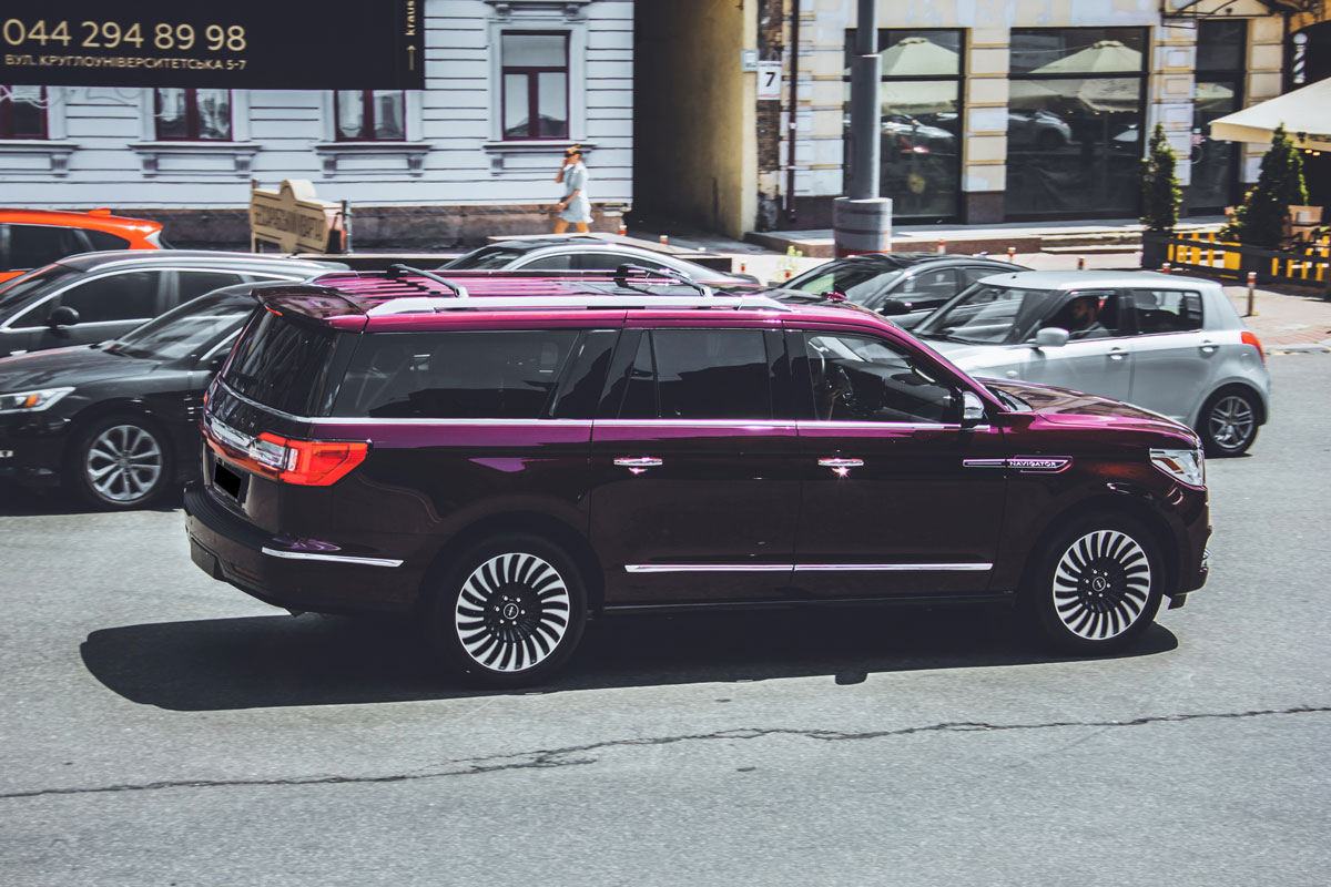 Purple Large luxury SUV Lincoln Navigator in the city