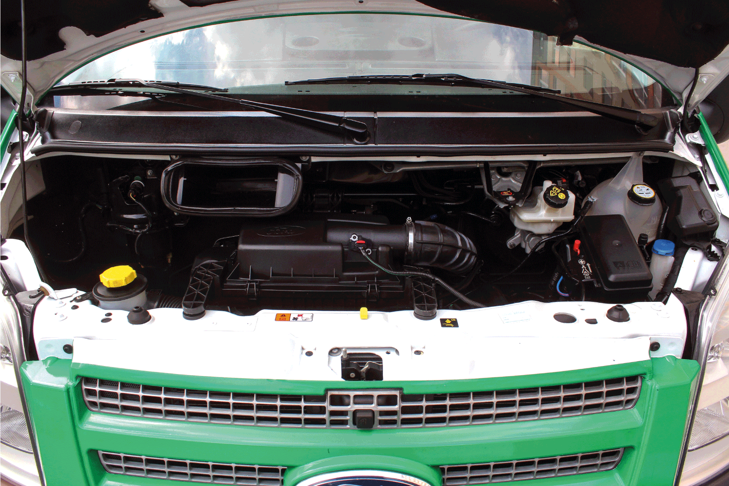 open hood of the engine bay of Ford vehicle
