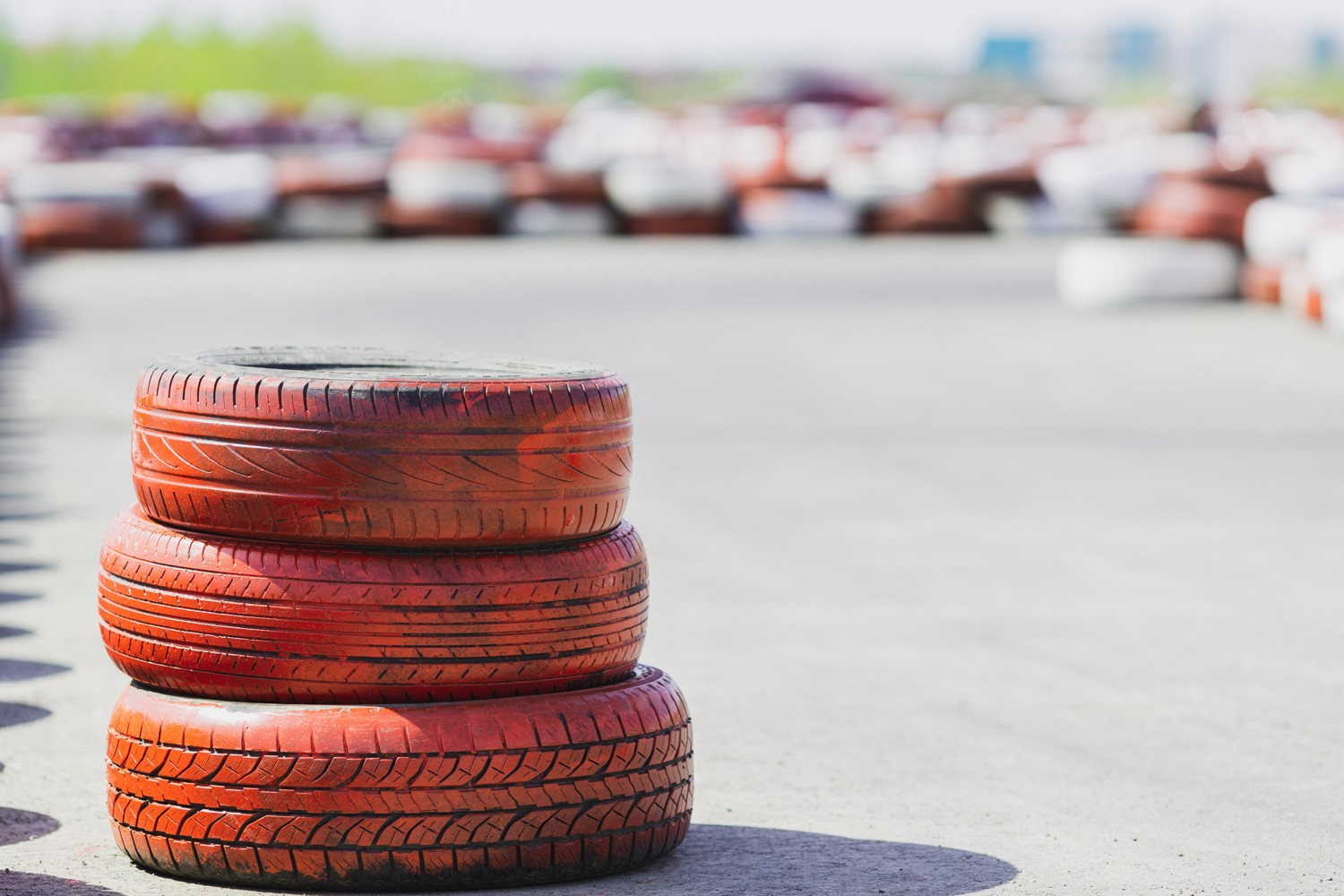 three car tires stacked on top of each other on an empty track race track, no one, pandemic empty tracks