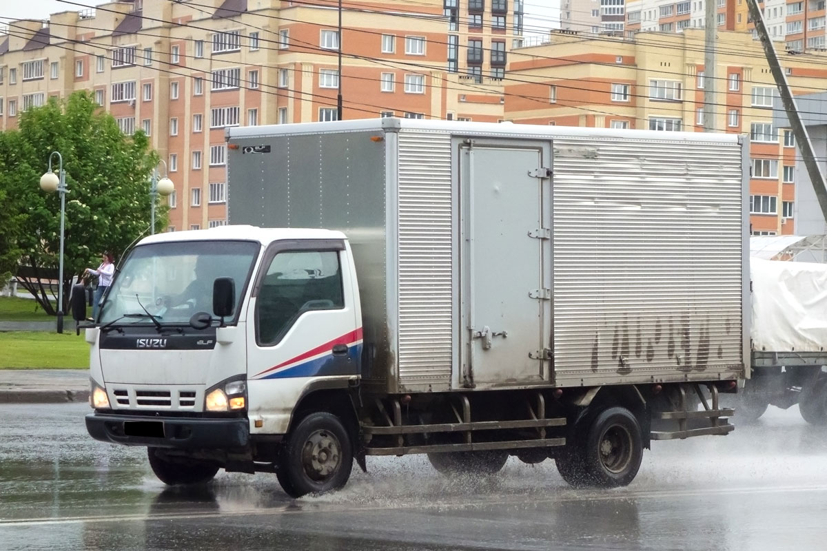 white color japanese box truck car chassis Isuzu Elf N Series (NMR NKR NPR), popular small cargo mini truck made in Japan driving on urban