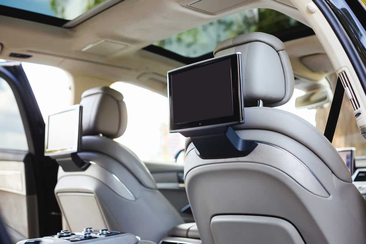 Entertainment system for rear passengers in a car with two monitors.