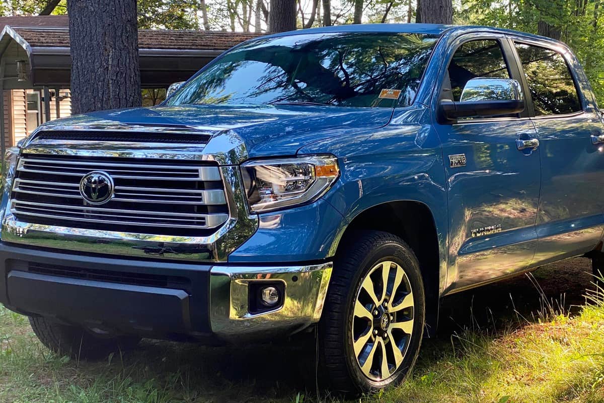 A big blue colored Toyota Tundra at a Forest area