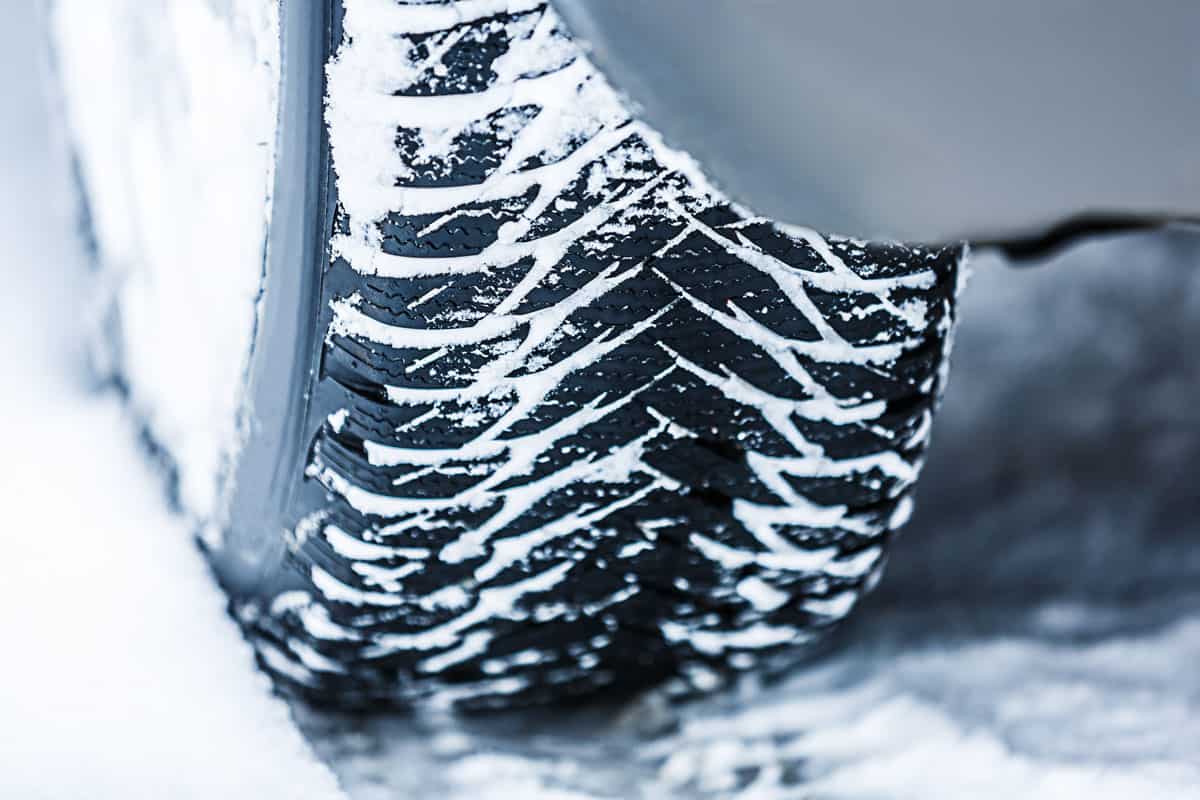 A big thread winter car tire moving on snow