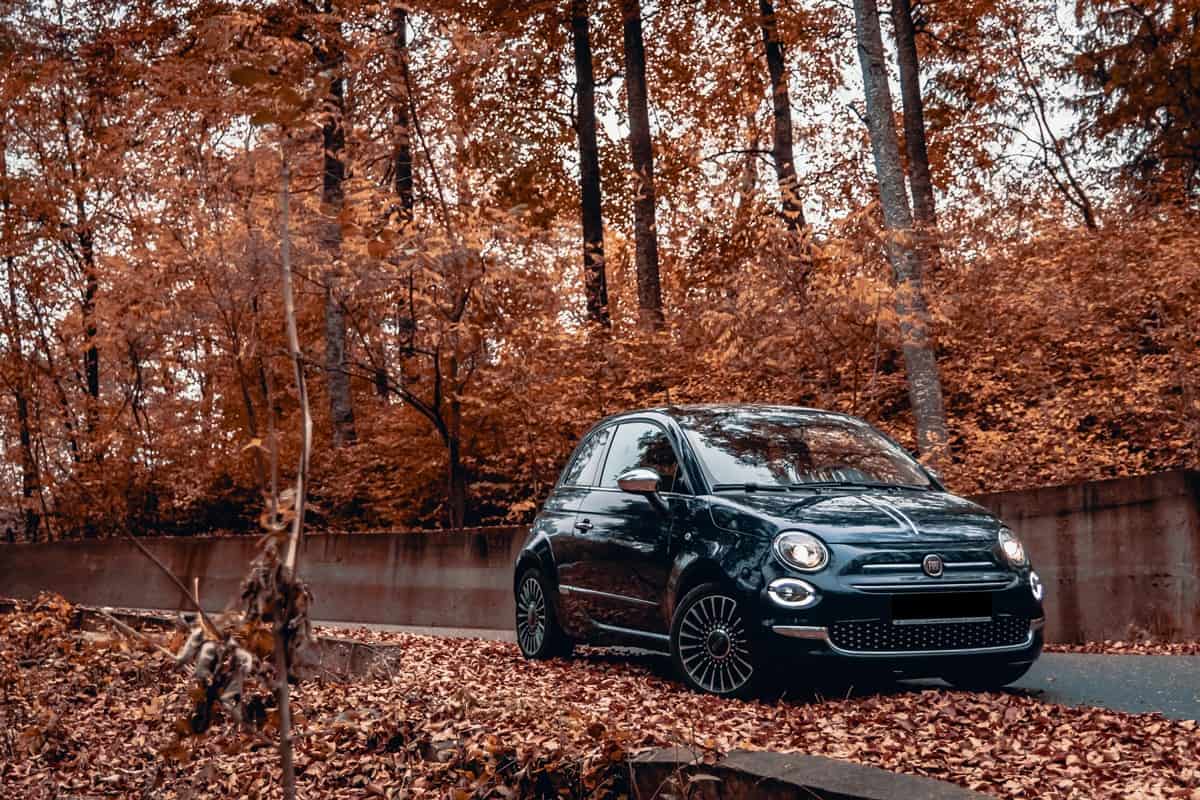 A black Fiat 500 parked on the road
