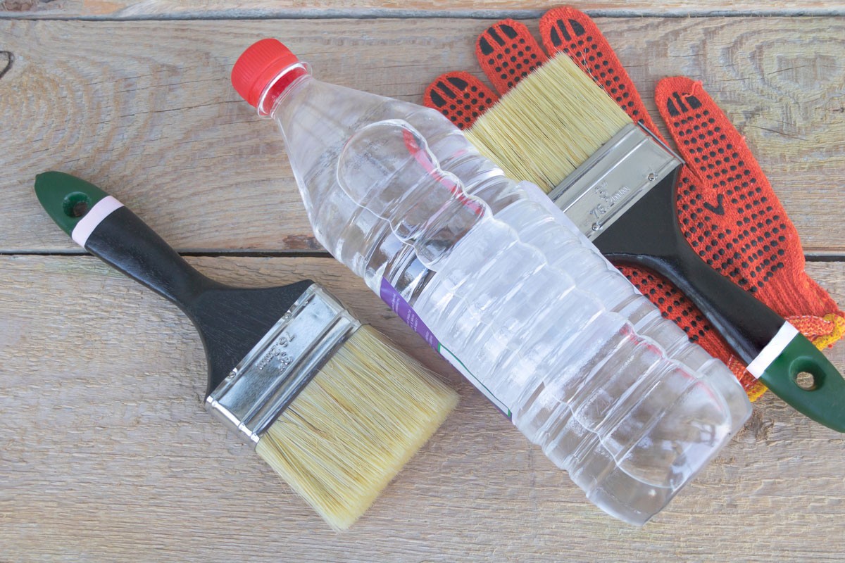 A bottle of acetone - two paintbrushes and gloves