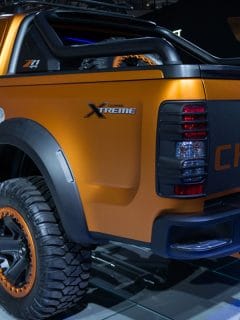 A matte orange Chevrolet Colorado Xtreme displayed on a turntable, Which Chevy Colorado Can Tow 7,000 Pounds?