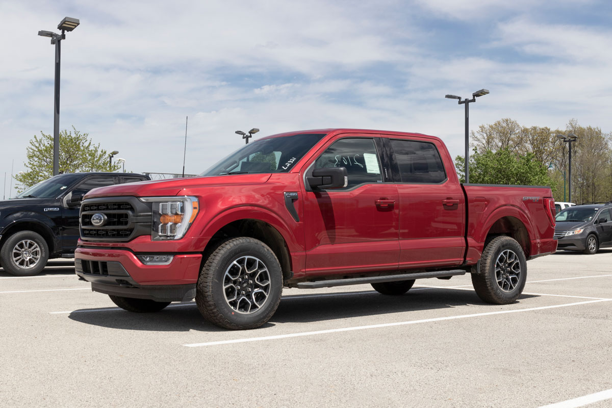 A red colored Ford F150 at the parking lot