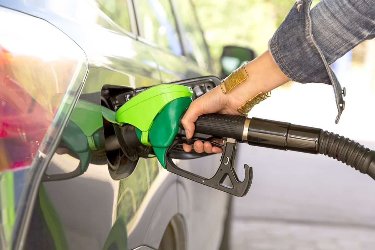 A woman's hand filling up gas