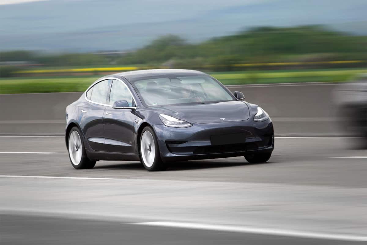 Black Tesla Model 3 at the highway