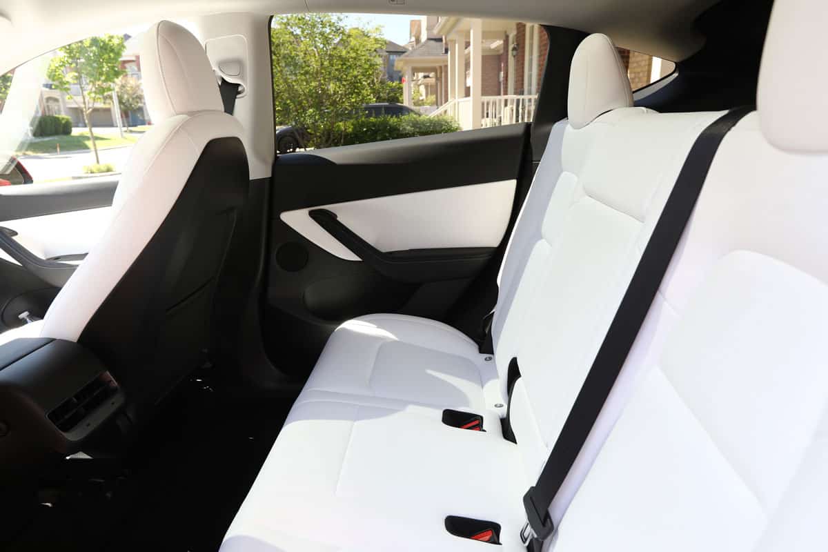 Brand new 2022 Tesla Model Y Dual Motor in red color with white and black interior. Modern electric vehicle