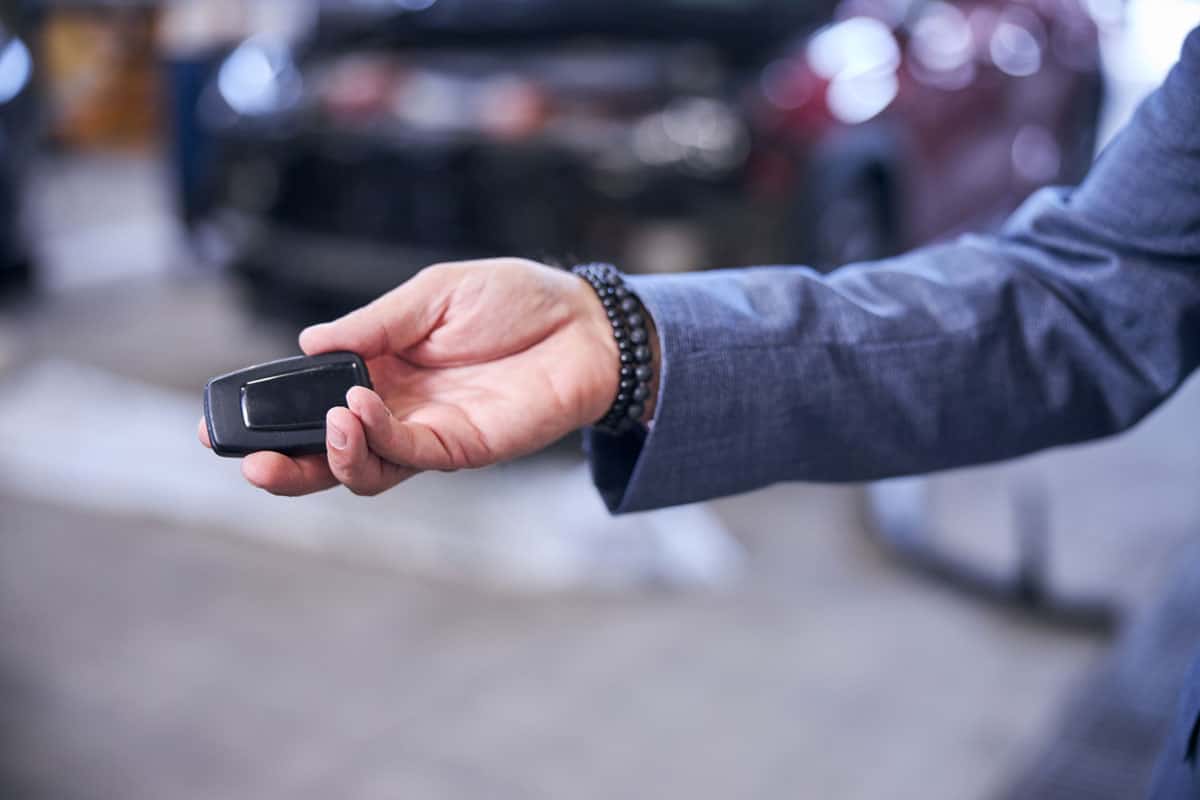 Car dealer handing out a transponder key