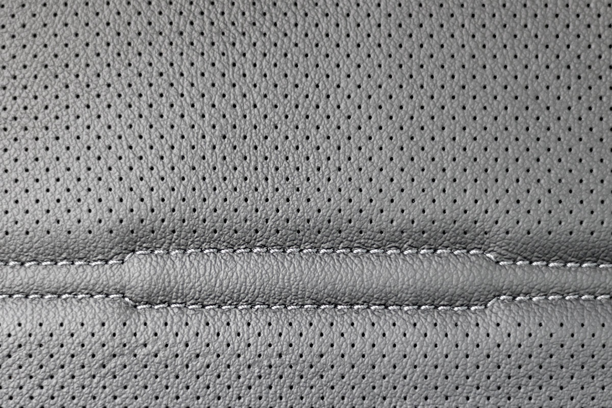 Car seat leather texture with seams, gray color, dotted
