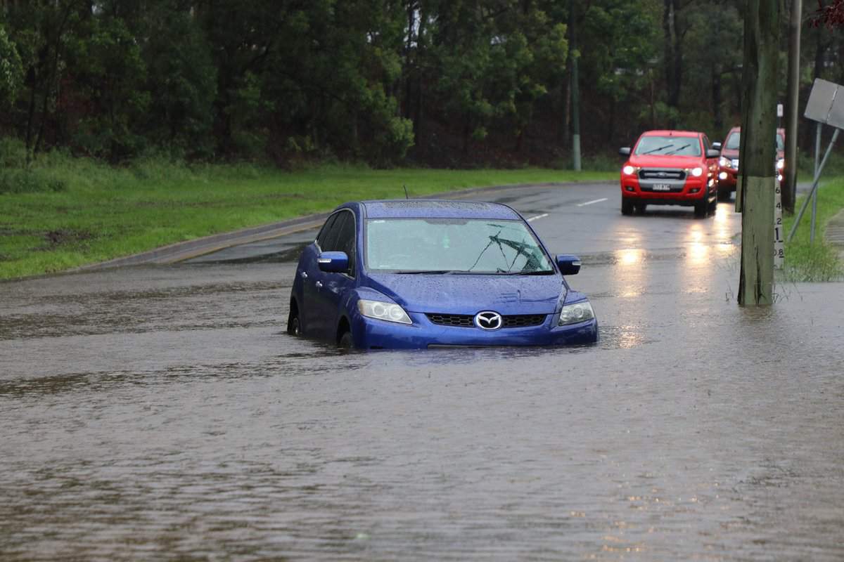 Car stuck in floodwater in the suburb of Rocklea from huge rainfall as a result of Tropical Cyclone