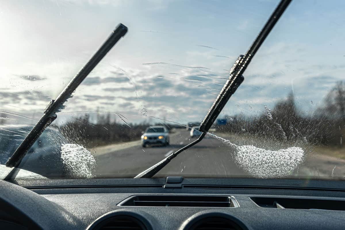 Car wipers clean windshields when driving in sunny weather
