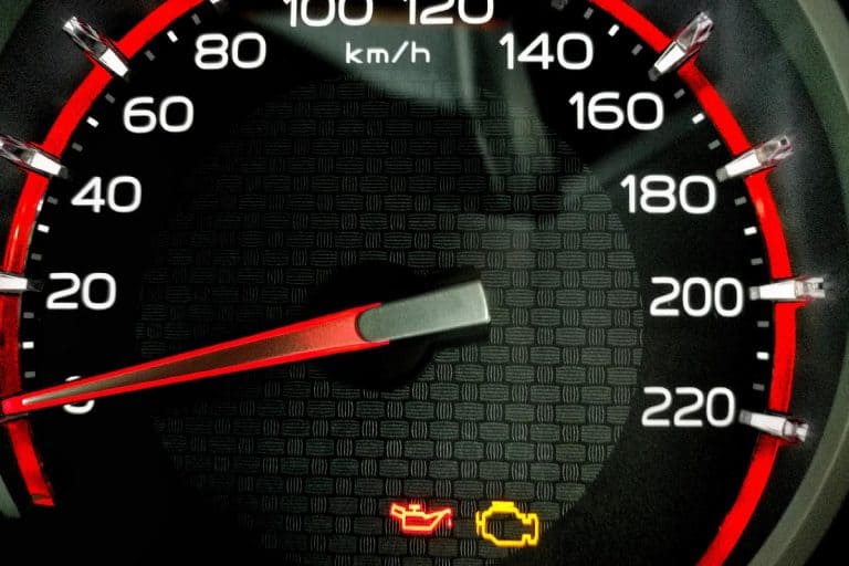 Check engine light and oil pressure red light icon on a car dashboard, Oil Light Comes On When Turning - What's Wrong?