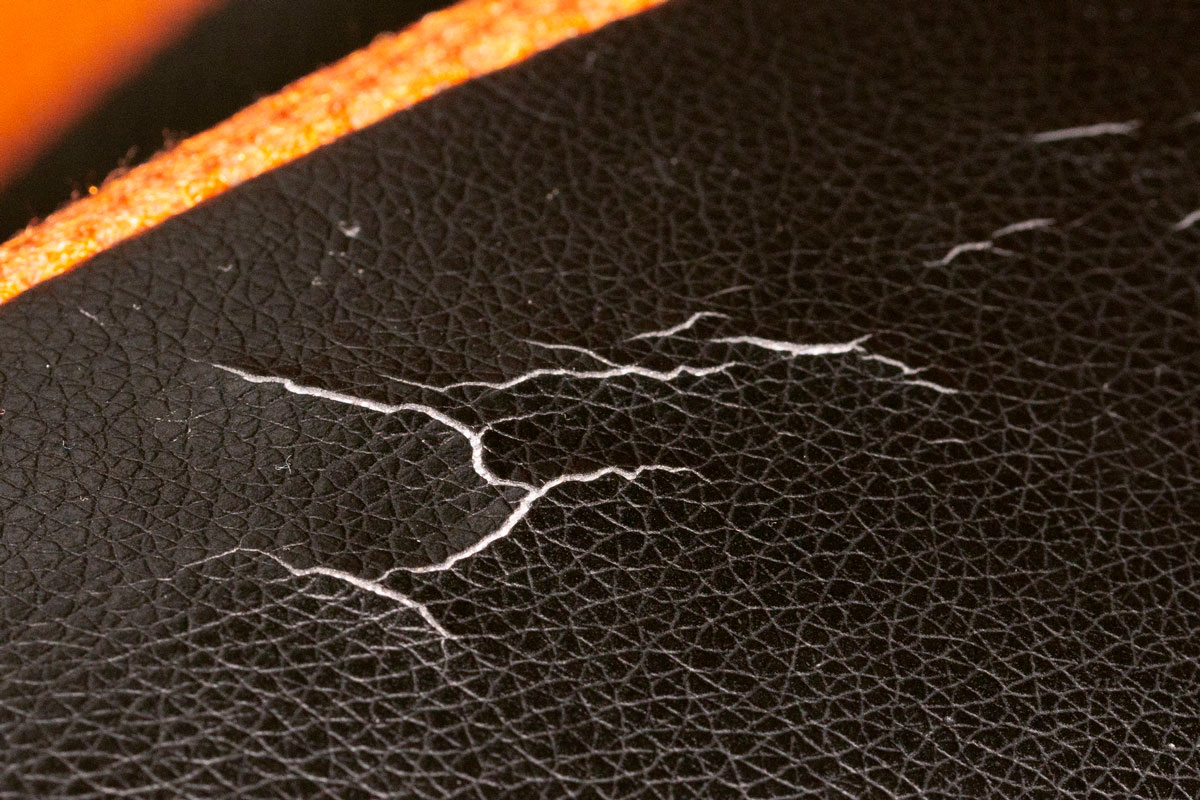 Cracked black leather on a car chair