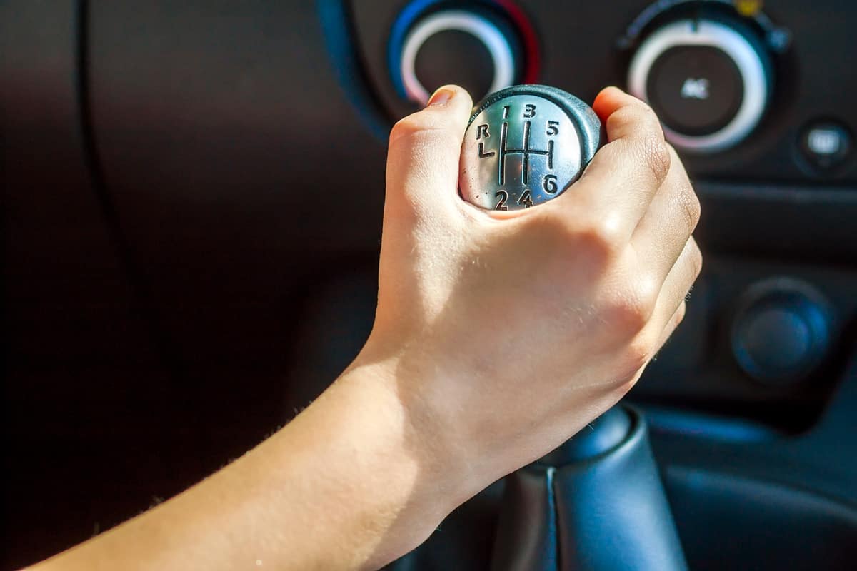 Driver hand shifting gear shift knob manually