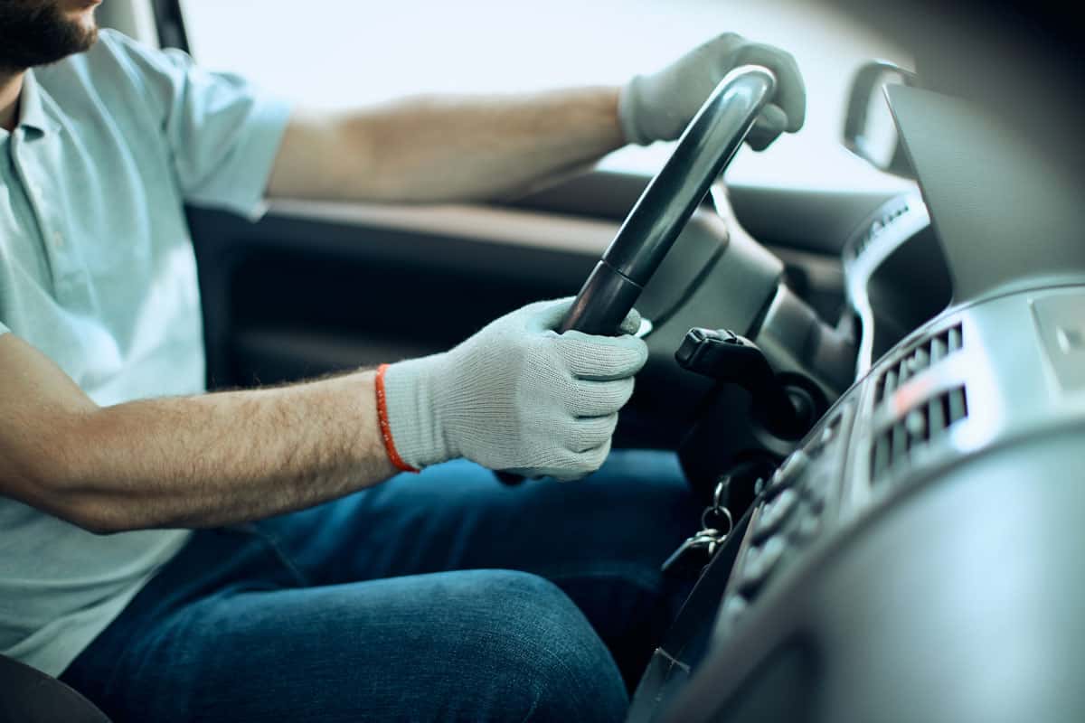 Driver wearing gloves holding the steering wheel