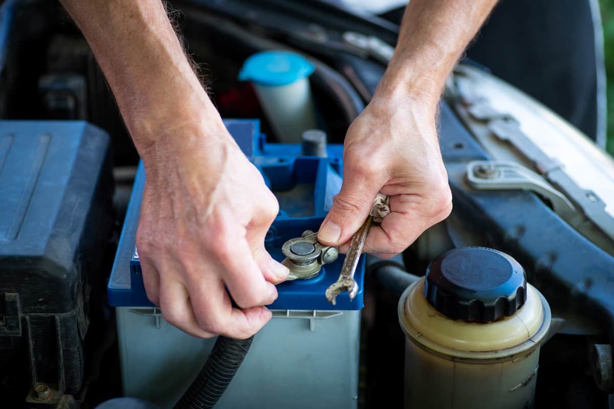 Mechanic removing a dead car battery