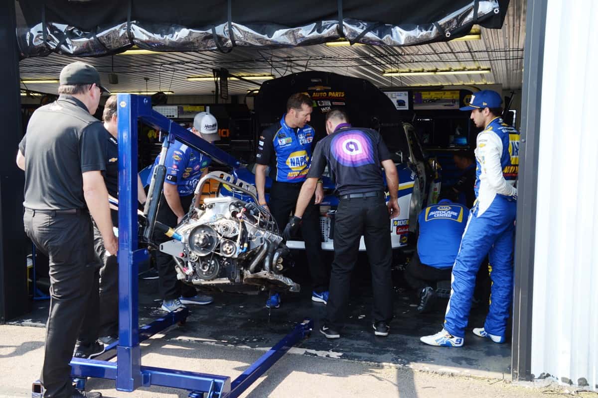 Mechanics swap an engine in NASCAR driver Chase Elliott's following practice for the 2019 NASCAR Gander RV 400 at Pocono Raceway in Pennsylvania.