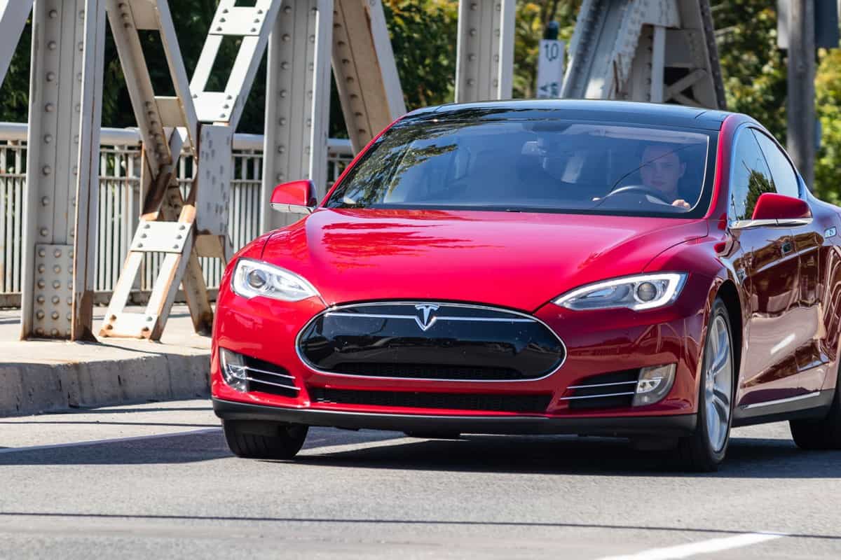 Red Tesla Model S Driving Across a Bridge
