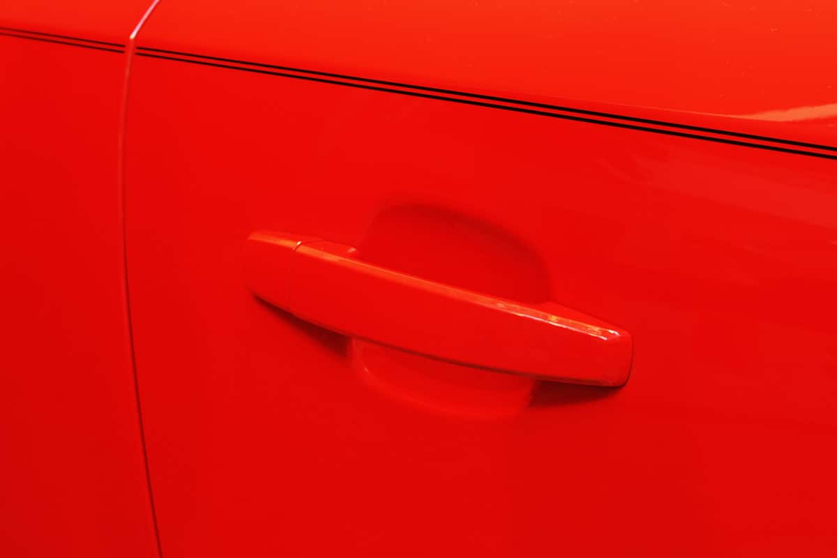 Sports car door handle in brilliant red.