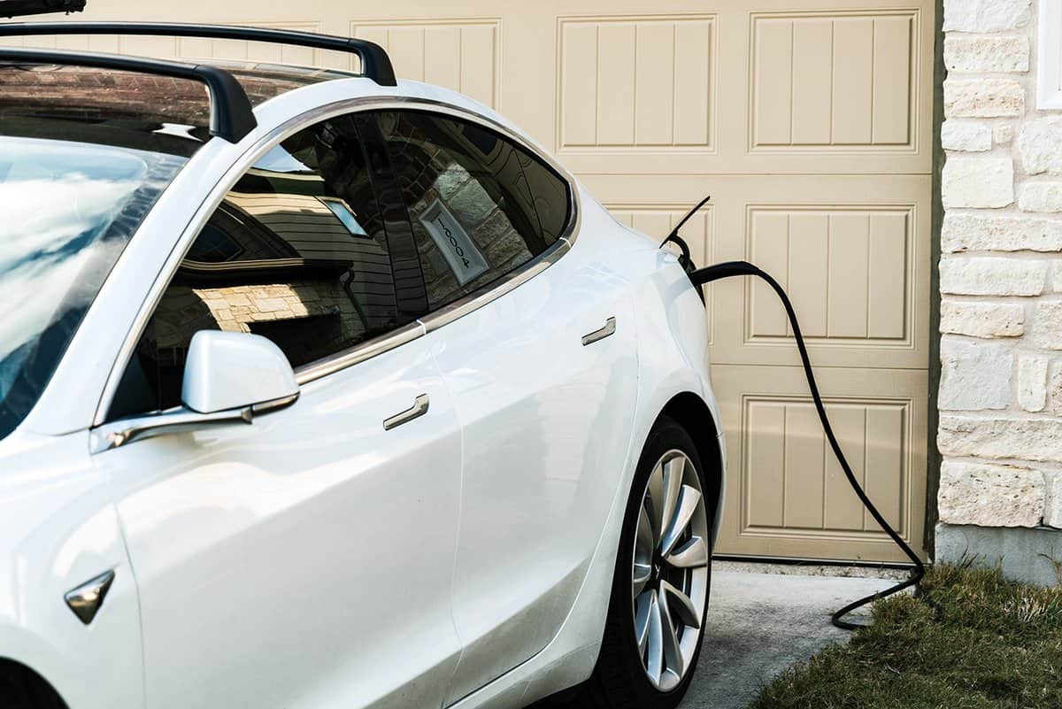 Tesla Model 3 charging at home in front of the house